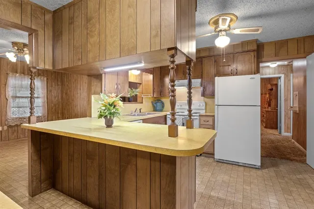a kitchen with a table and refrigerator