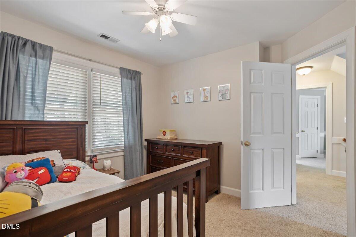 1808 Thorpshire Drive Raleigh, NC 27615 - Photo 12 of 17 a bedroom with a bed and a dresser