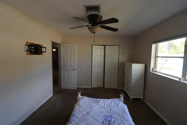 a bedroom with a bed and a window