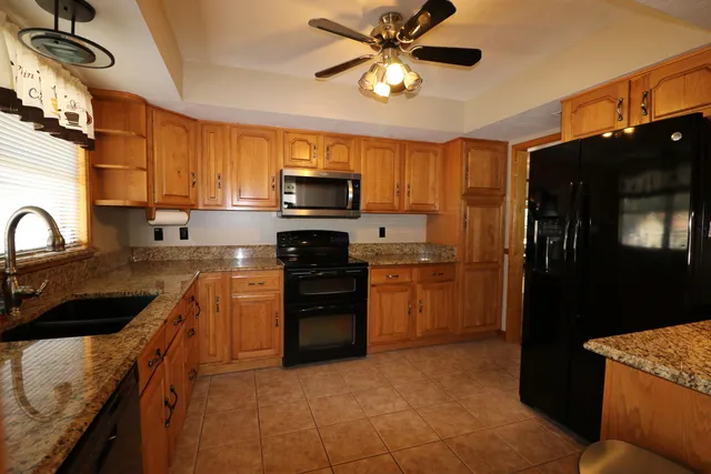 a kitchen with a sink stainless steel appliances and cabinets