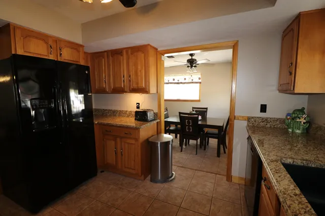 a kitchen with sink and refrigerator