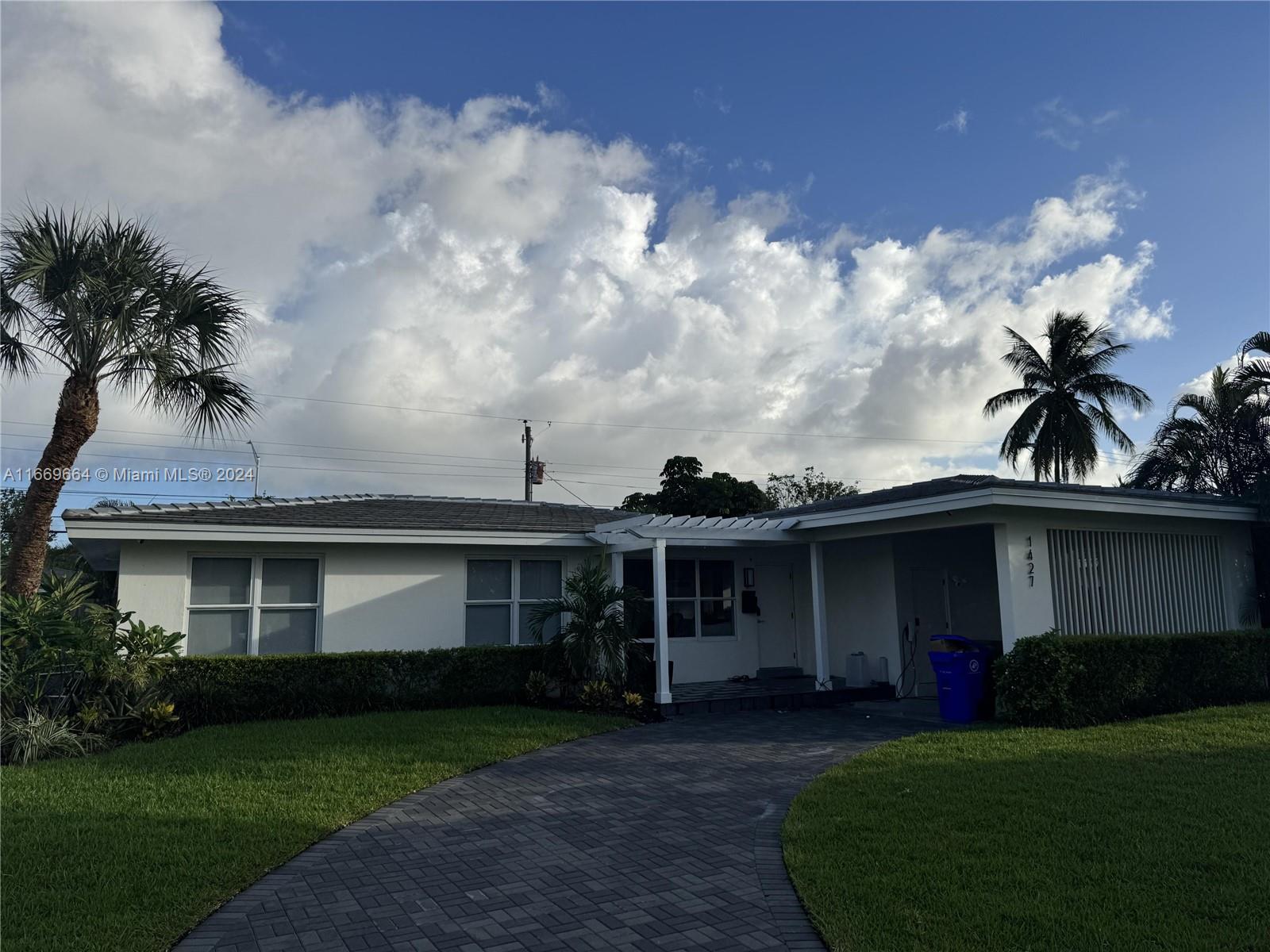 1427 Northeast 60th Street Fort Lauderdale, FL 33334 - Photo 1 of 3 a front view of a house with garden