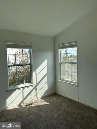 an empty room with wooden floor and a window