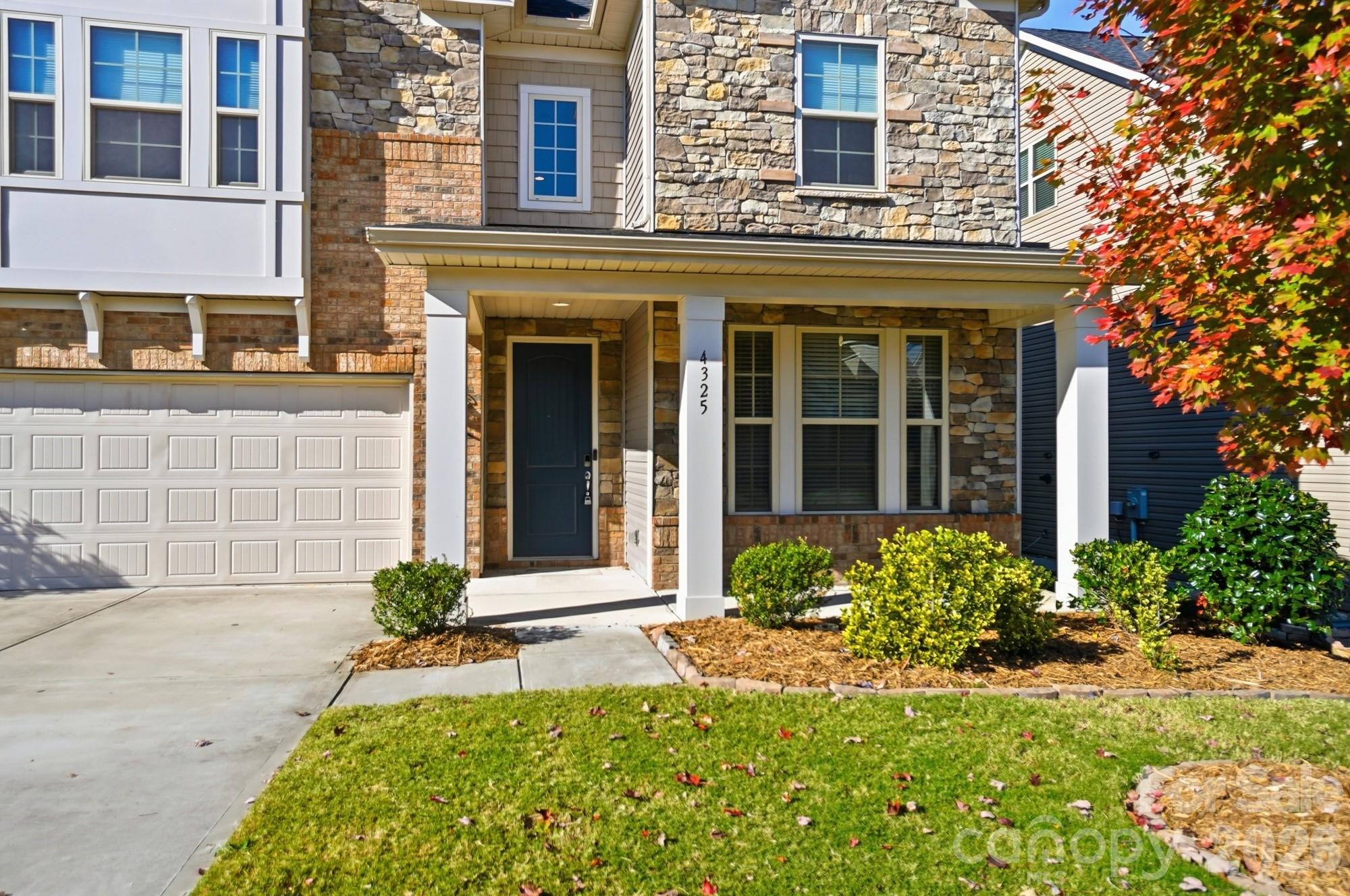4325 Hunton Dale Road Northwest Concord, NC 28027 - Photo 1 of 42 front view of a brick house with a large windows