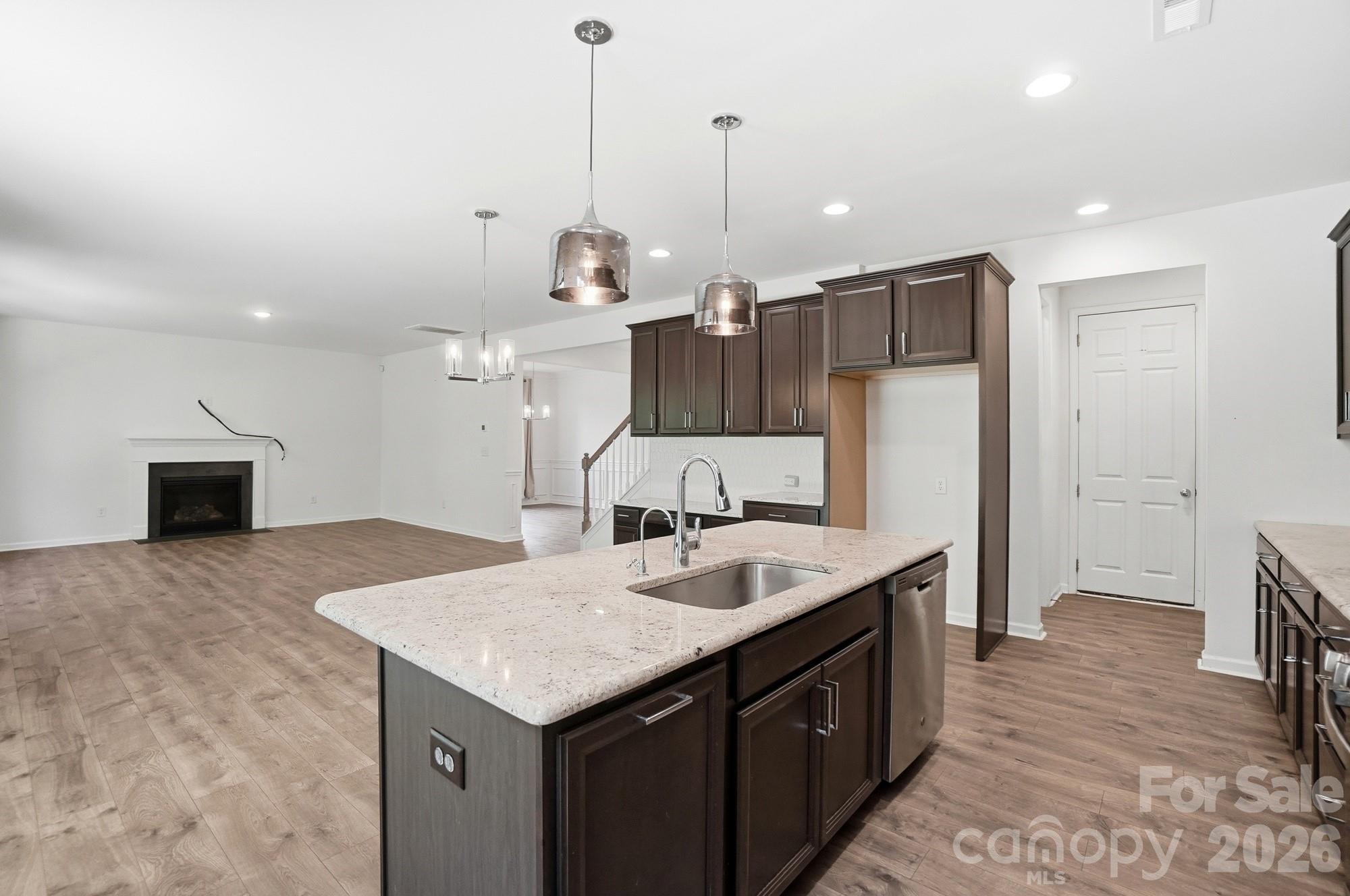 4325 Hunton Dale Road Northwest Concord, NC 28027 - Photo 12 of 42 a kitchen with kitchen island a sink stove and wooden floor