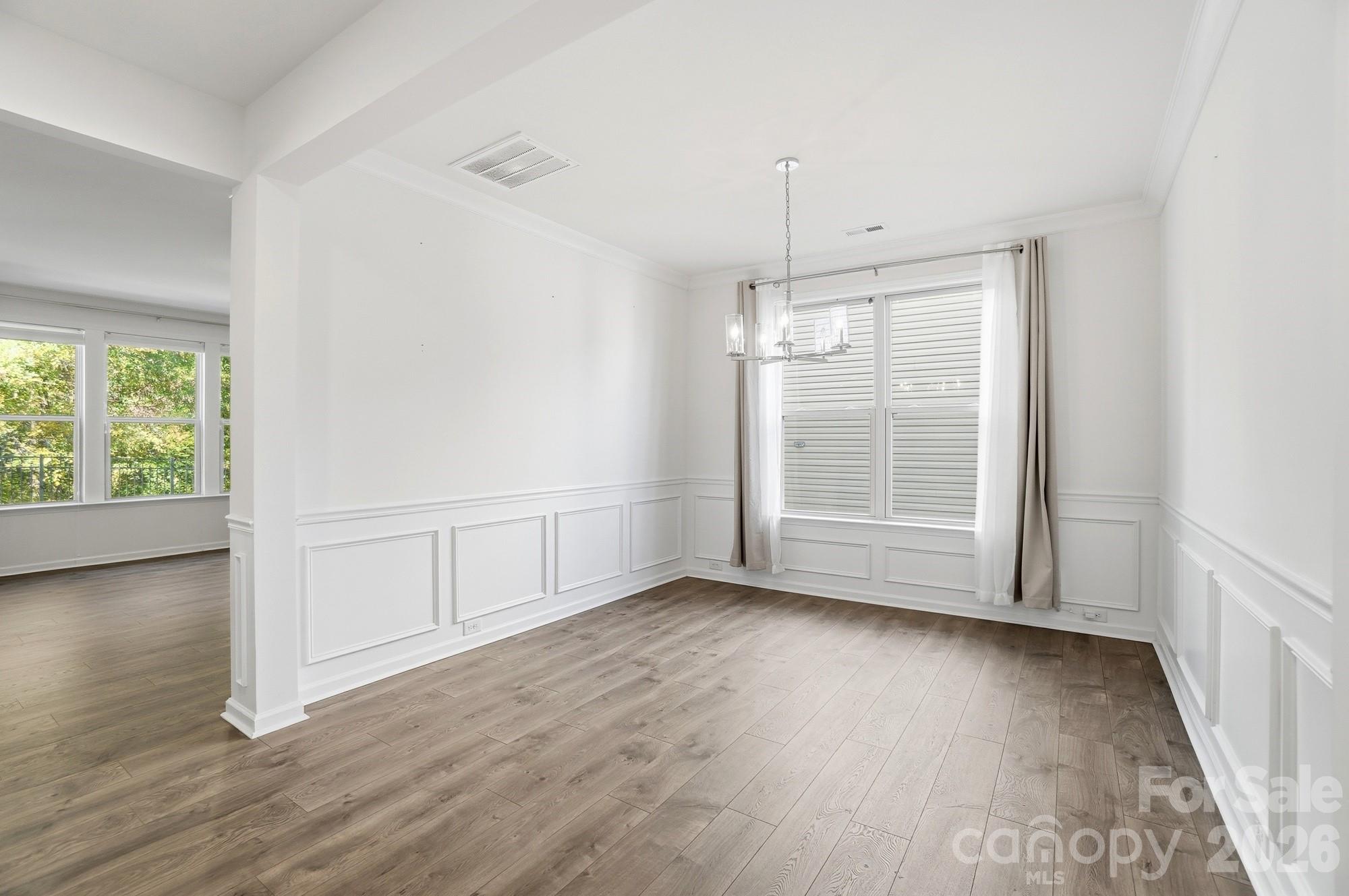 4325 Hunton Dale Road Northwest Concord, NC 28027 - Photo 18 of 42 an empty room with wooden floor and windows