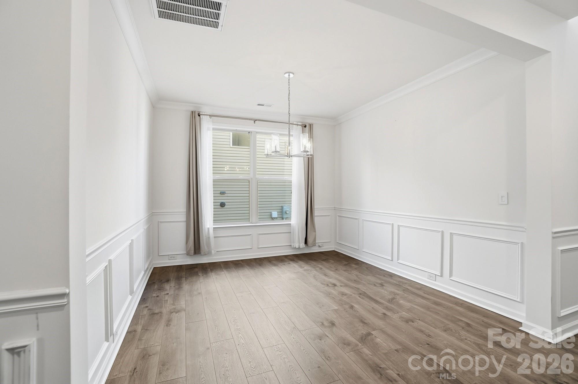 4325 Hunton Dale Road Northwest Concord, NC 28027 - Photo 19 of 42 a view of an empty room with wooden floor and a window