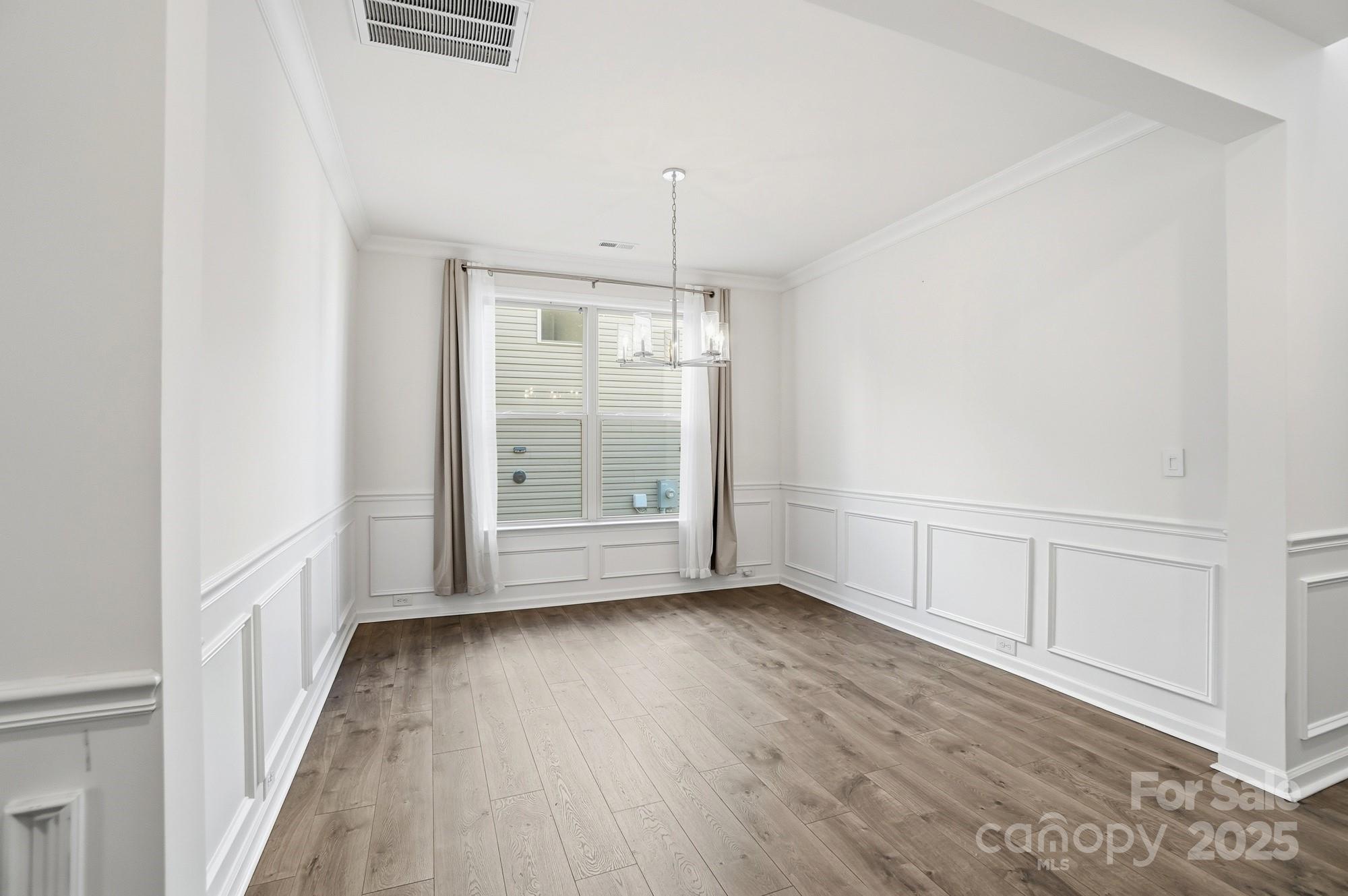 4325 Hunton Dale Road Northwest Concord, NC 28027 - Photo 20 of 42 a view of an empty room with wooden floor and a window