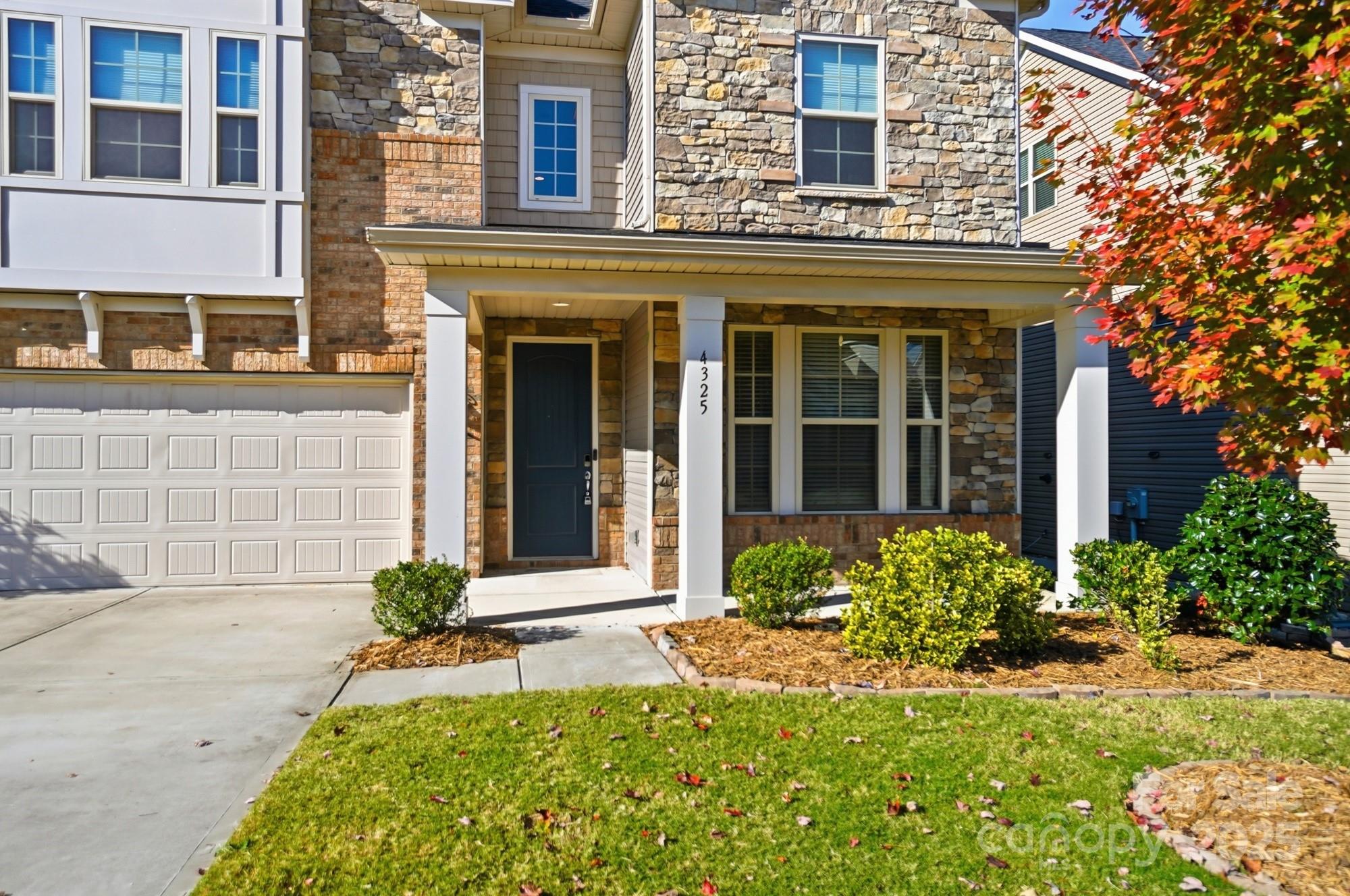 4325 Hunton Dale Road Northwest Concord, NC 28027 - Photo 2 of 42 front view of a brick house with a large windows