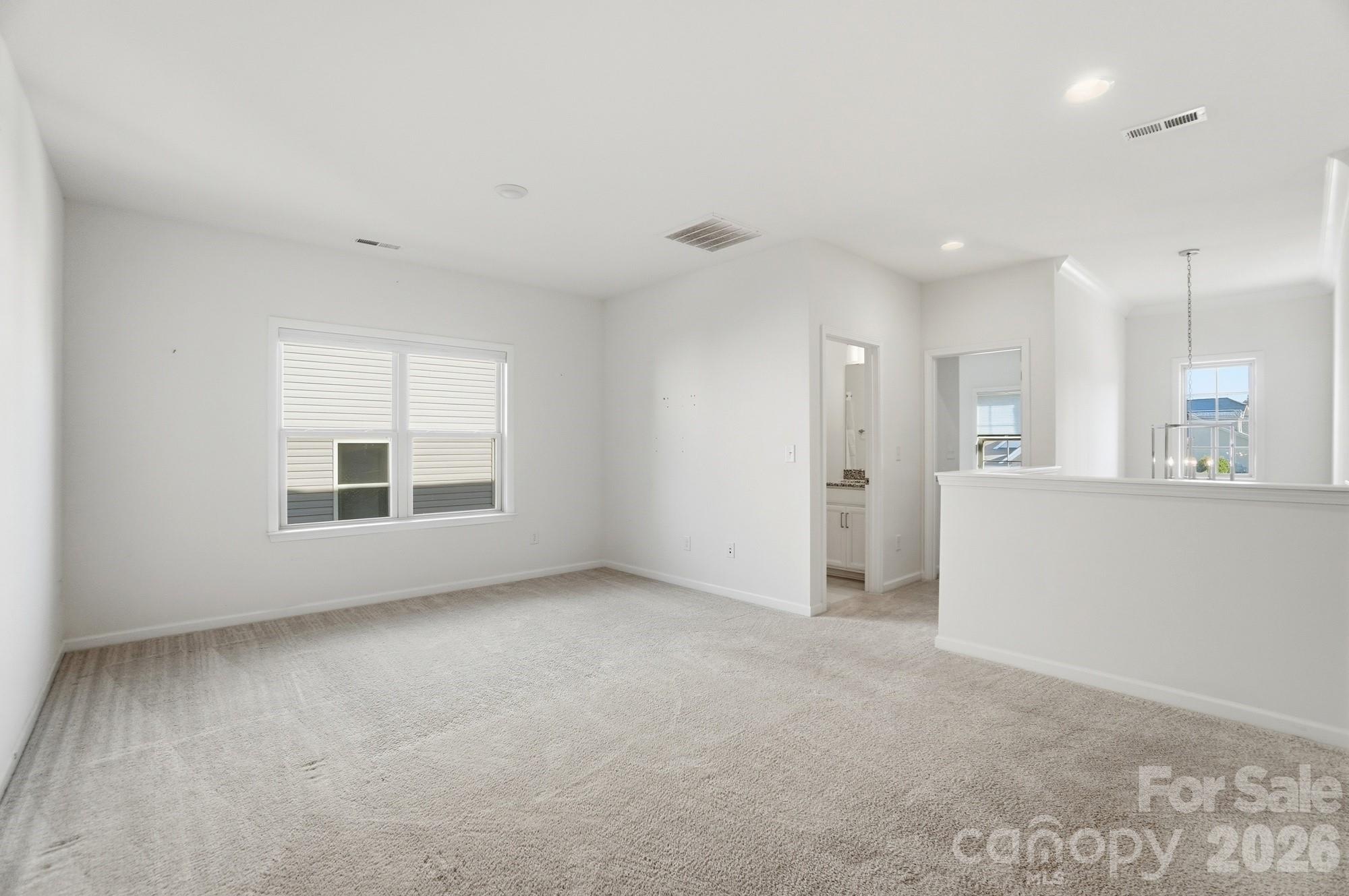 4325 Hunton Dale Road Northwest Concord, NC 28027 - Photo 21 of 42 a view of an empty room with kitchen and a window