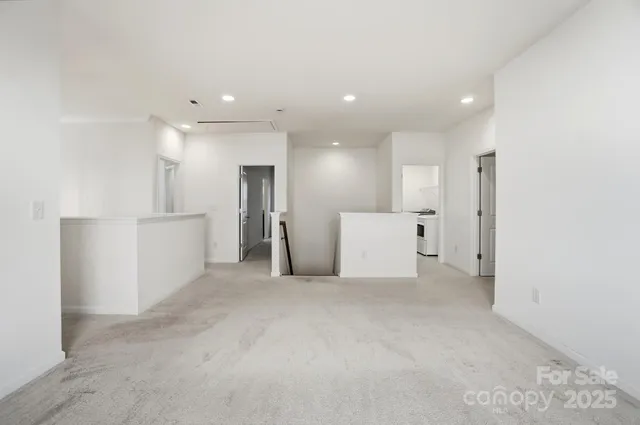 a view of a big room with refrigerator and white walls