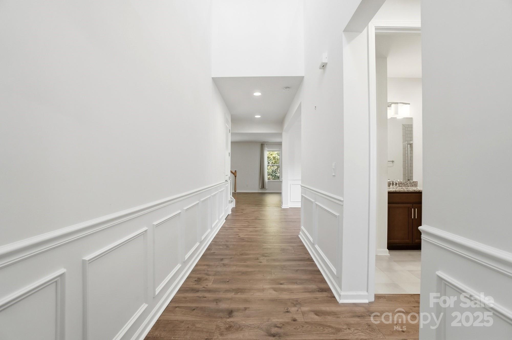 4325 Hunton Dale Road Northwest Concord, NC 28027 - Photo 3 of 42 a view of a hallway with wooden floor and staircase