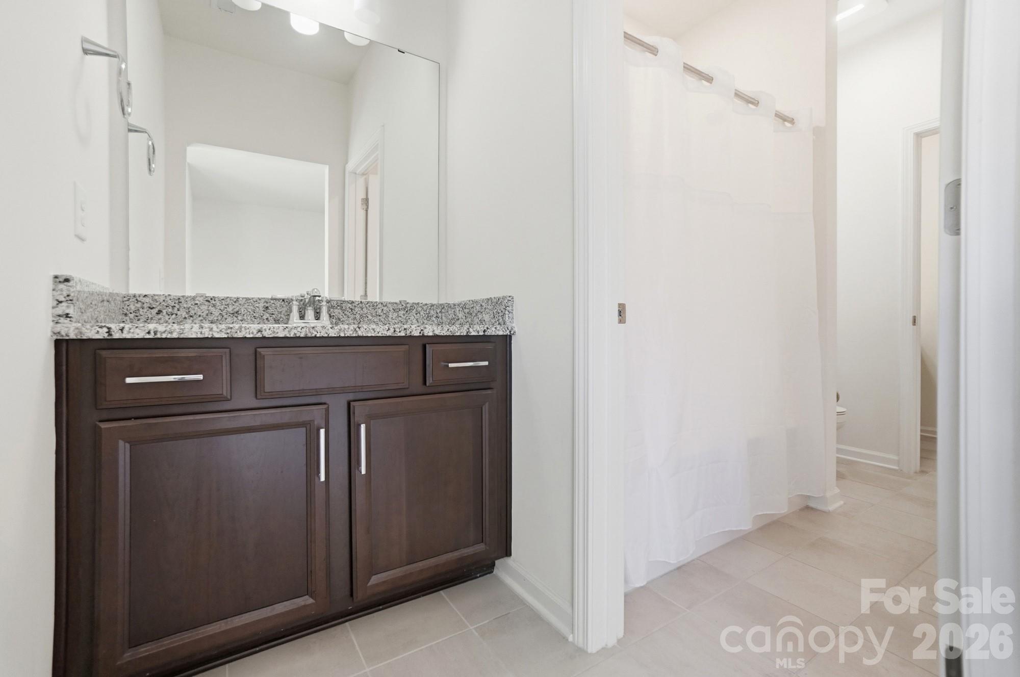 4325 Hunton Dale Road Northwest Concord, NC 28027 - Photo 35 of 42 a bathroom with a granite countertop sink and a mirror