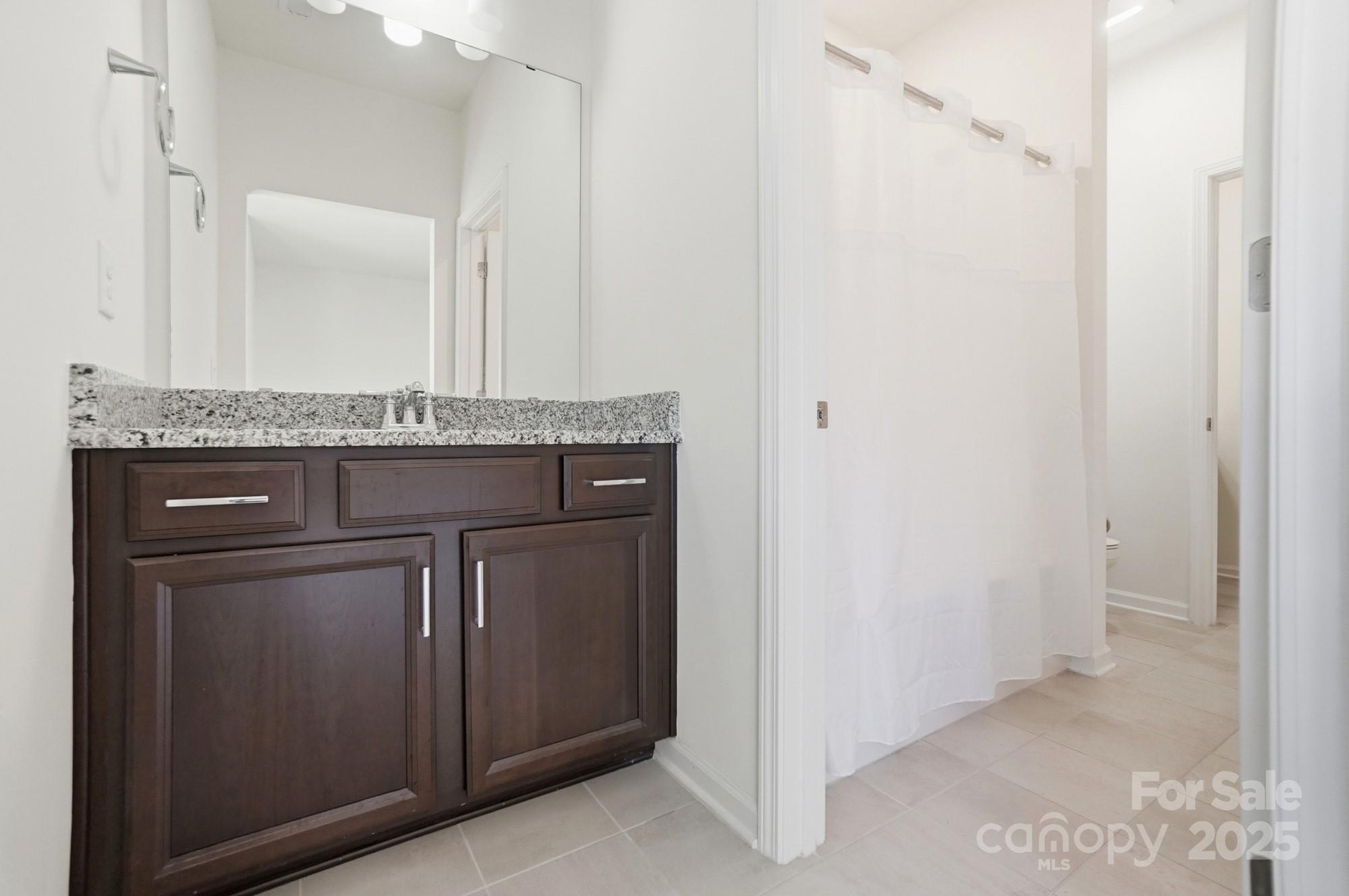 4325 Hunton Dale Road Northwest Concord, NC 28027 - Photo 36 of 42 a bathroom with a granite countertop sink and a mirror