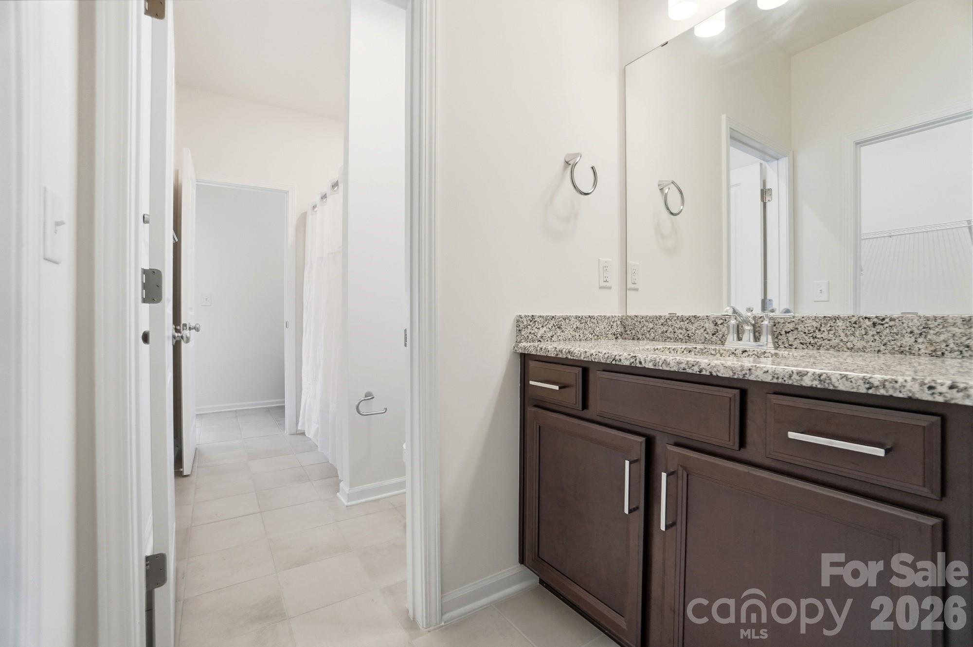 4325 Hunton Dale Road Northwest Concord, NC 28027 - Photo 36 of 42 a bathroom with a granite countertop sink and mirror