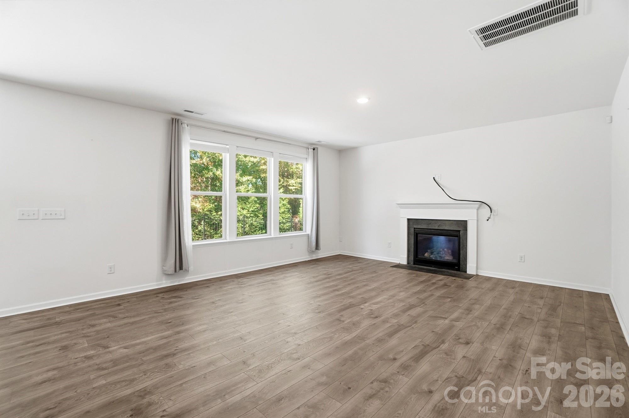 4325 Hunton Dale Road Northwest Concord, NC 28027 - Photo 4 of 42 a view of empty room with wooden floor and fireplace