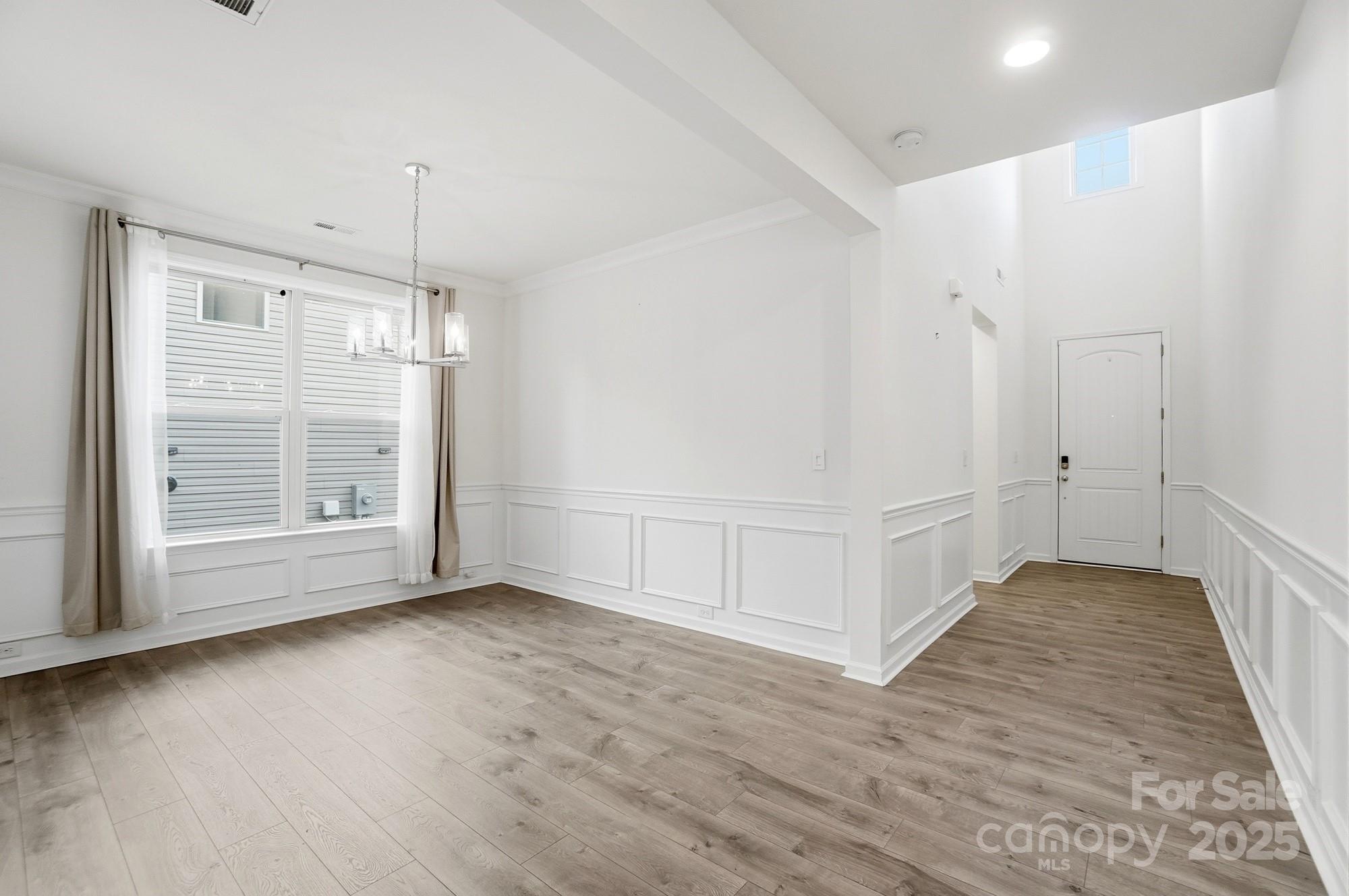4325 Hunton Dale Road Northwest Concord, NC 28027 - Photo 4 of 42 a view of an empty room with wooden floor and a window