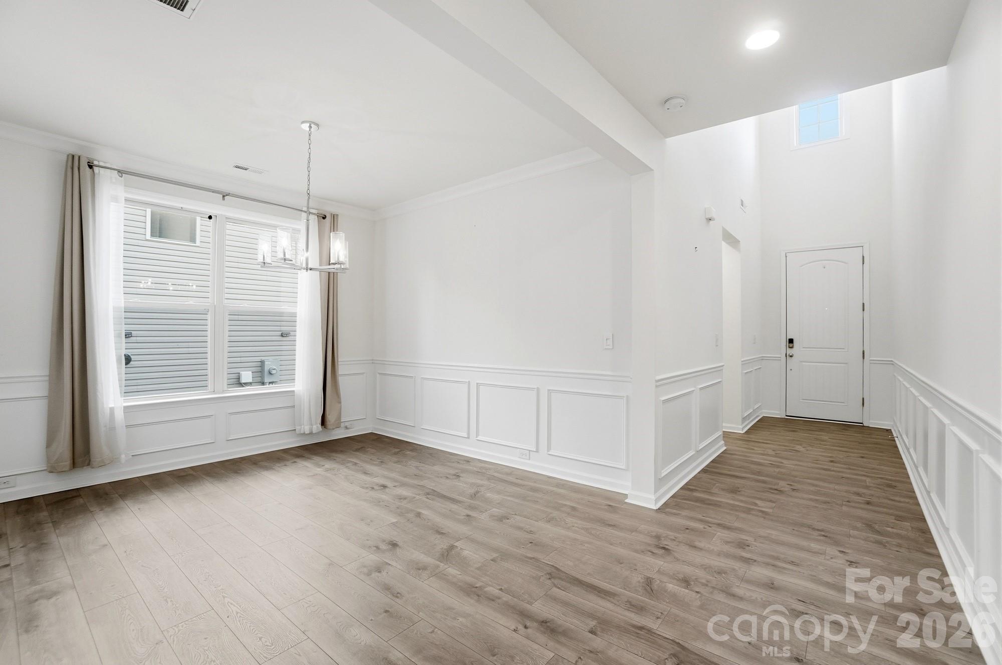 4325 Hunton Dale Road Northwest Concord, NC 28027 - Photo 6 of 42 a view of an empty room with wooden floor and a window