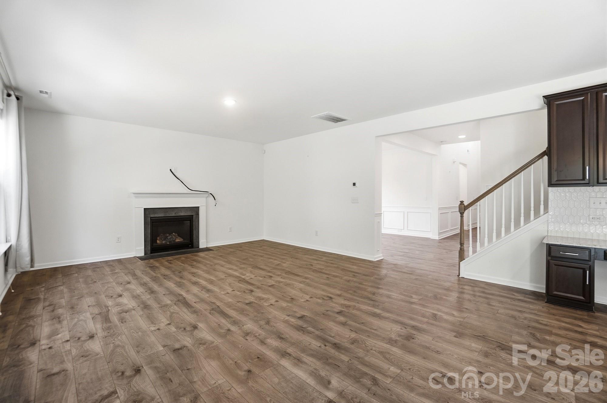 4325 Hunton Dale Road Northwest Concord, NC 28027 - Photo 7 of 42 a view of empty room with fireplace and wooden floor
