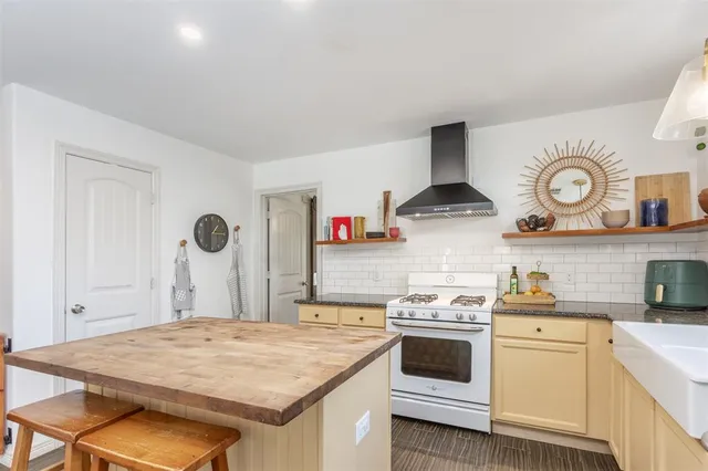a kitchen with a stove and a white refrigerator