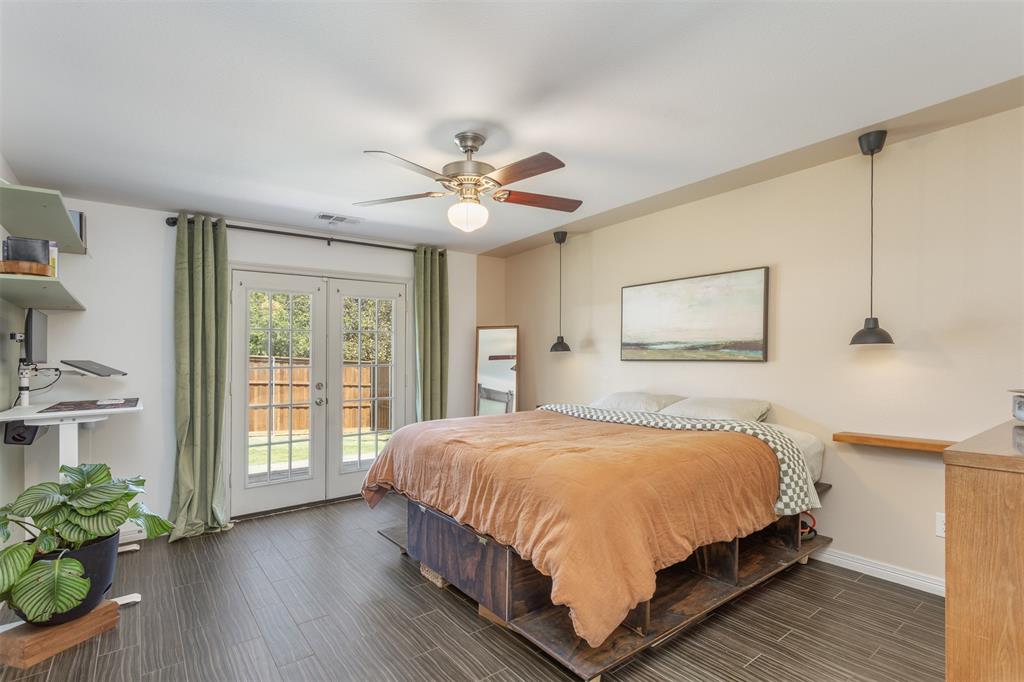 1211 Garcia Street McKinney, TX 75069 - Photo 12 of 27 a bedroom with a large bed a chandelier and windows