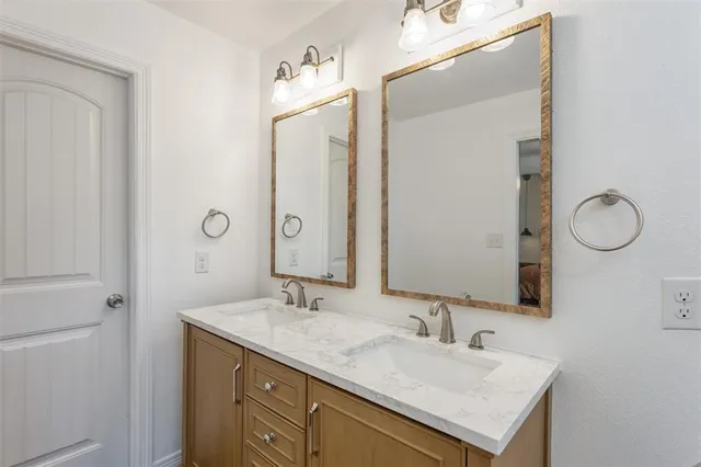 a bathroom with a sink vanity and mirror