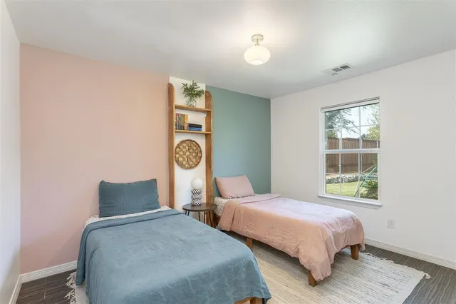 a bedroom with two beds and a window