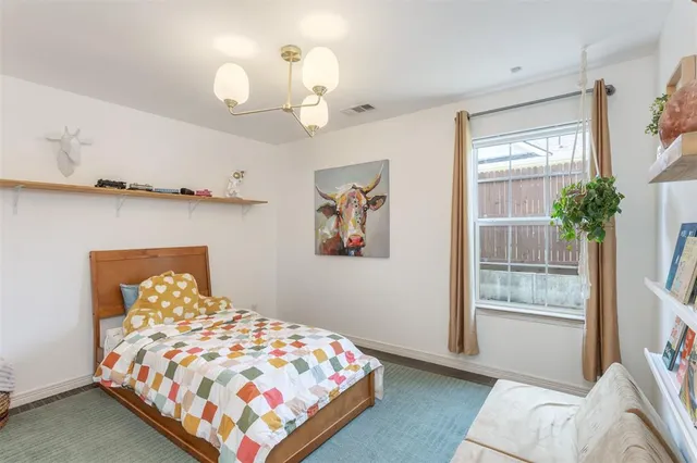 a bedroom with bed and wooden floor