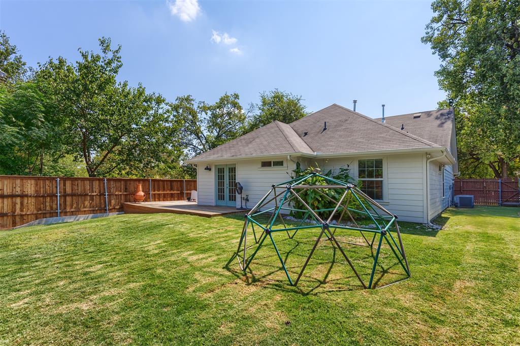 1211 Garcia Street McKinney, TX 75069 - Photo 25 of 27 a view of a house with backyard and a slide