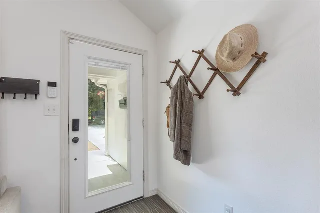 a view of a hallway with a door and a glass door
