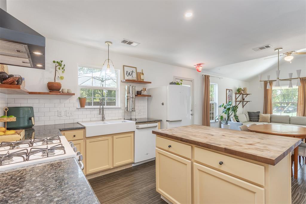 1211 Garcia Street McKinney, TX 75069 - Photo 9 of 27 a kitchen with sink stove and cabinets