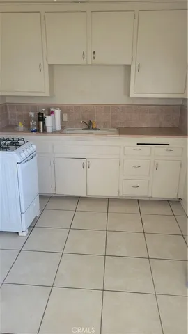 a kitchen with cabinets and appliances