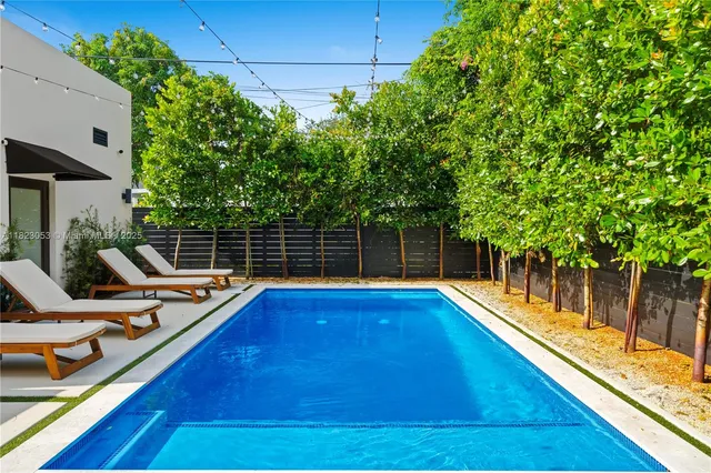 a view of a backyard with swimming pool
