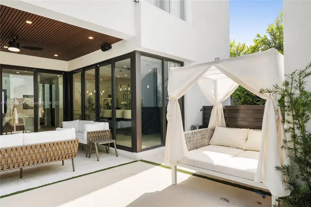 a view of a patio with a table and chairs