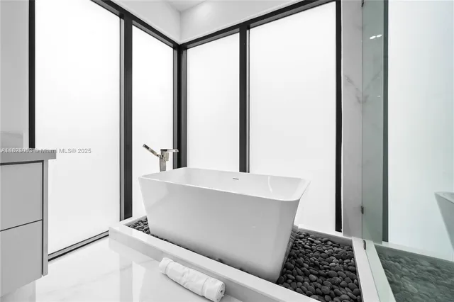 a bedroom with bed couch and window