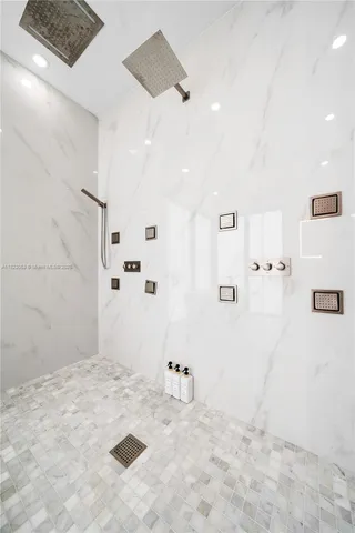 a bedroom with a bed and a large mirror