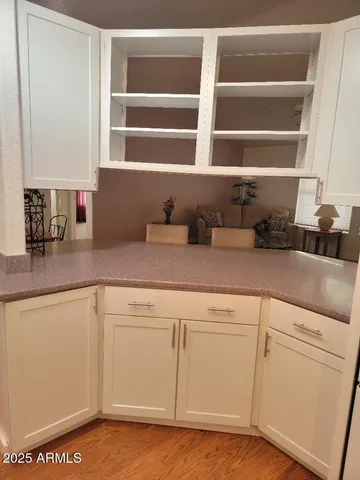 a kitchen with granite countertop cabinets and window