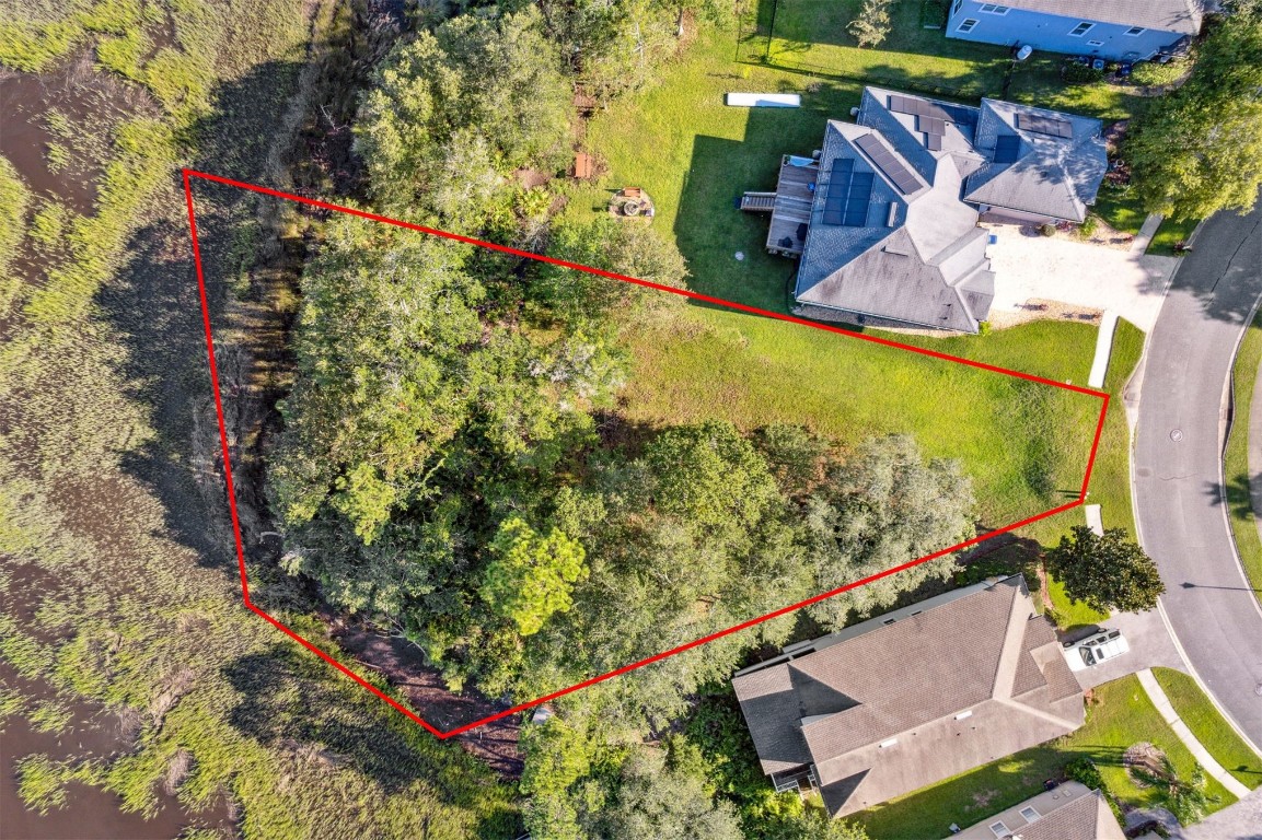 96282 Windsor Drive Yulee, FL 32097 - Photo 2 of 35 an aerial view of a house with a yard and black swimming pool