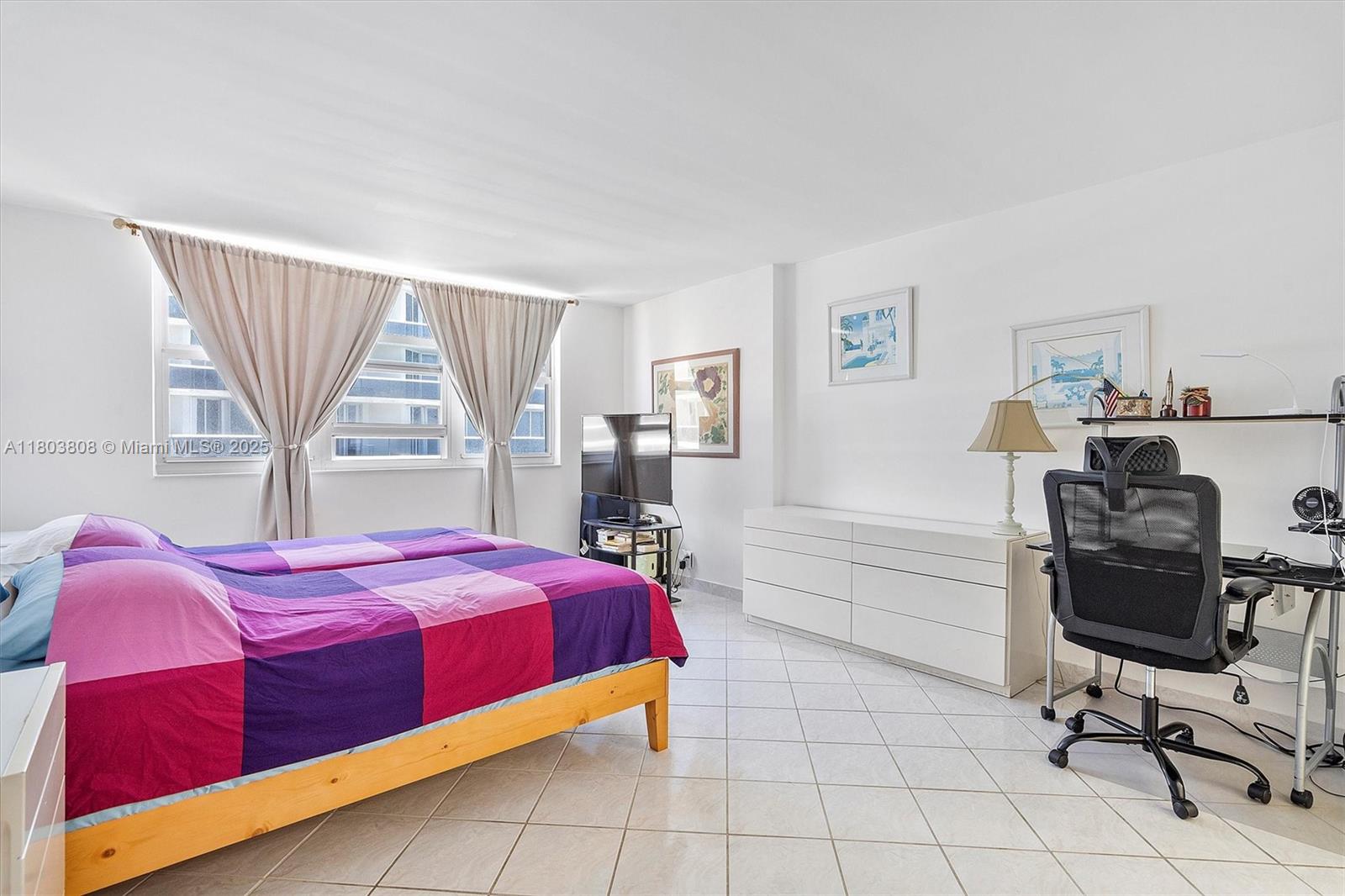 9511 Collins Avenue, Unit 1002 Surfside, FL 33154 - Photo 11 of 27 a bedroom with a bed and a window