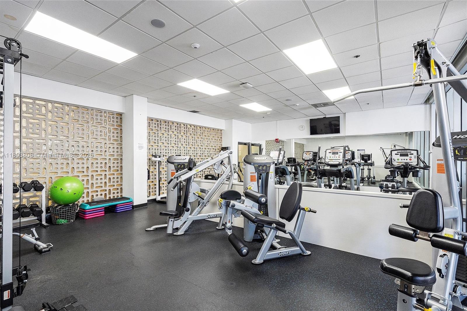 9511 Collins Avenue, Unit 1002 Surfside, FL 33154 - Photo 17 of 27 a view of a room with gym equipment