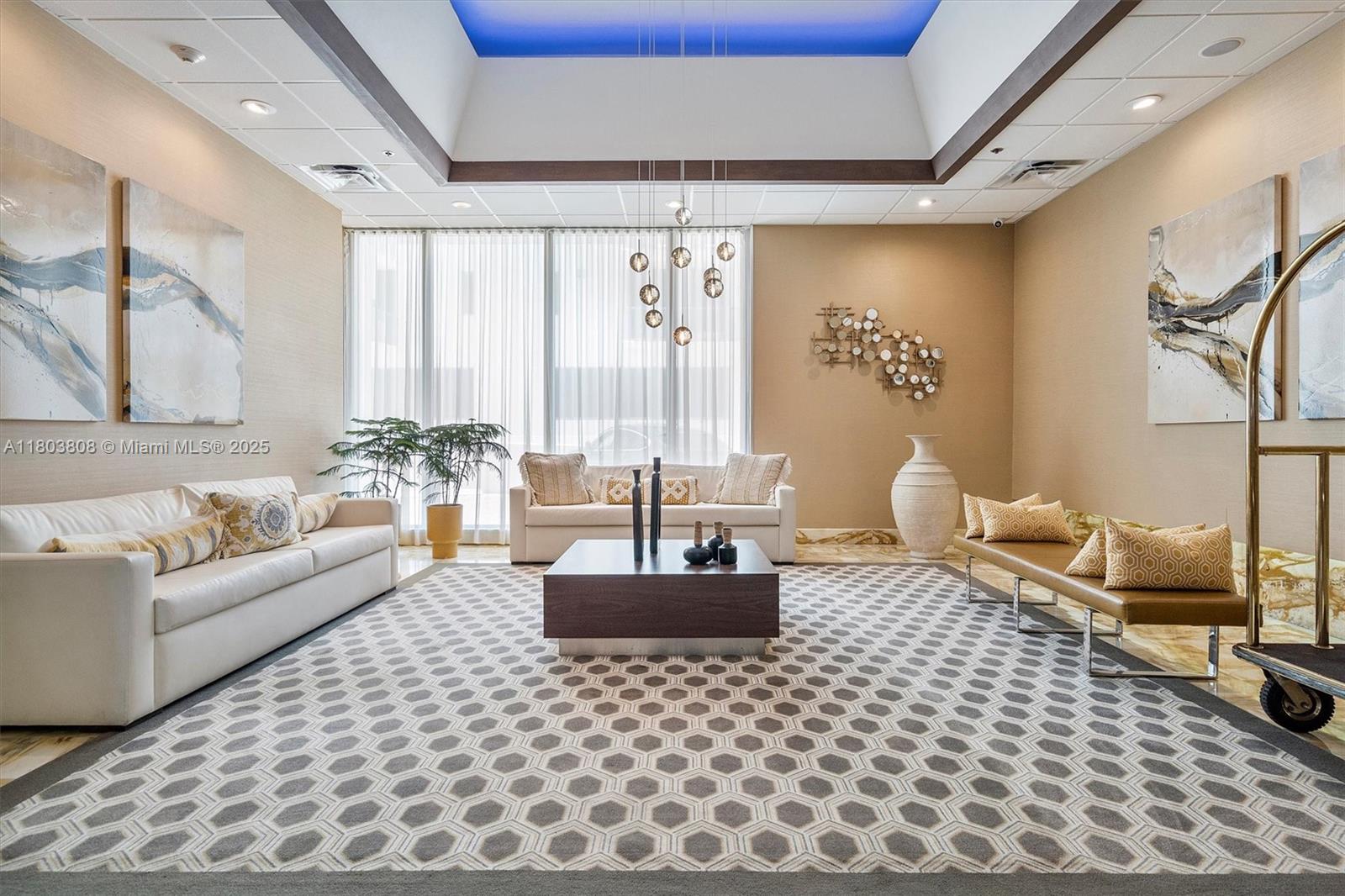 9511 Collins Avenue, Unit 1002 Surfside, FL 33154 - Photo 22 of 27 a living room with furniture and a large window