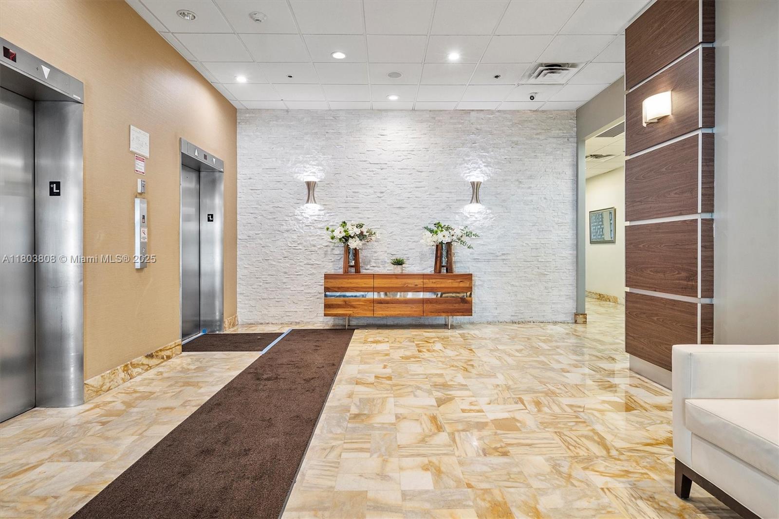 9511 Collins Avenue, Unit 1002 Surfside, FL 33154 - Photo 23 of 27 a bathroom with a tub shower and sink