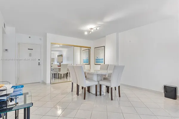 a kitchen with stainless steel appliances a stove a sink and white cabinets