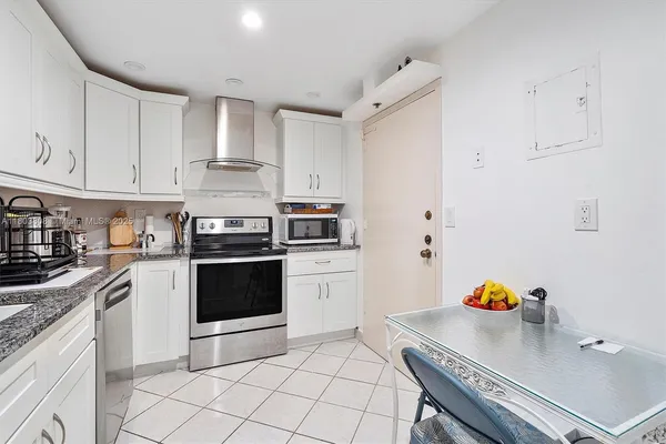 a kitchen with a sink cabinets and refrigerator