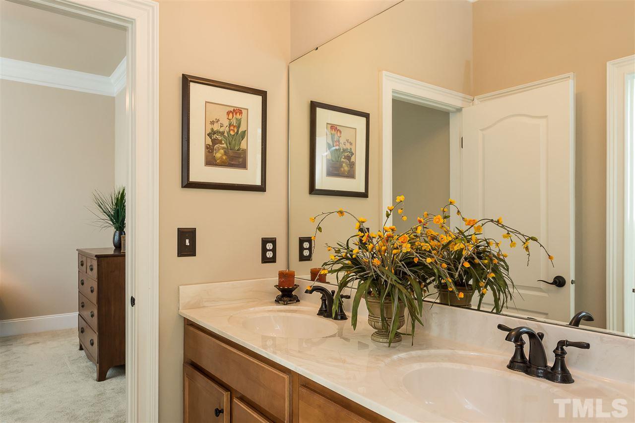 3929 Colinwood Lane Raleigh, NC 27606 - Photo 13 of 24 a bathroom with a sink and a mirror