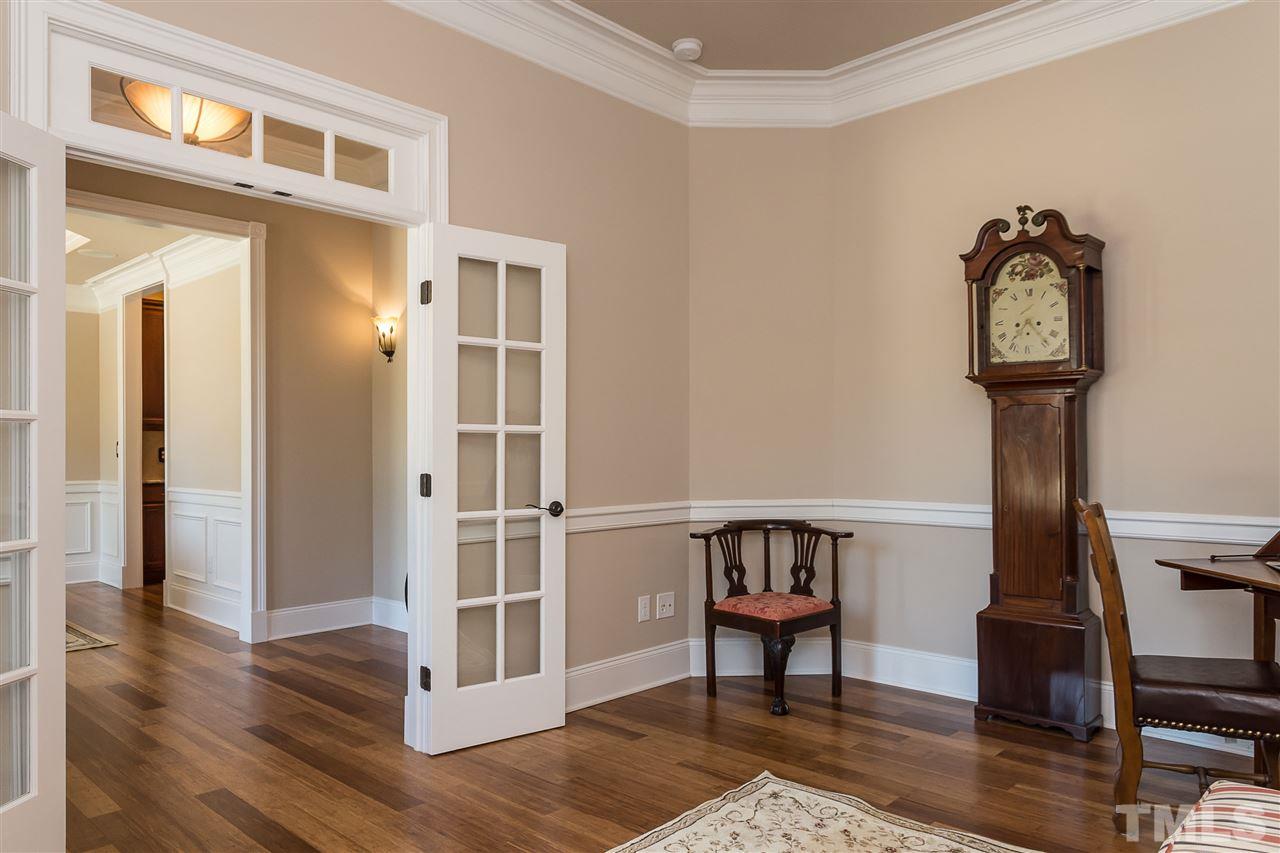 3929 Colinwood Lane Raleigh, NC 27606 - Photo 15 of 24 a view of a hallway with wooden floor and workspace