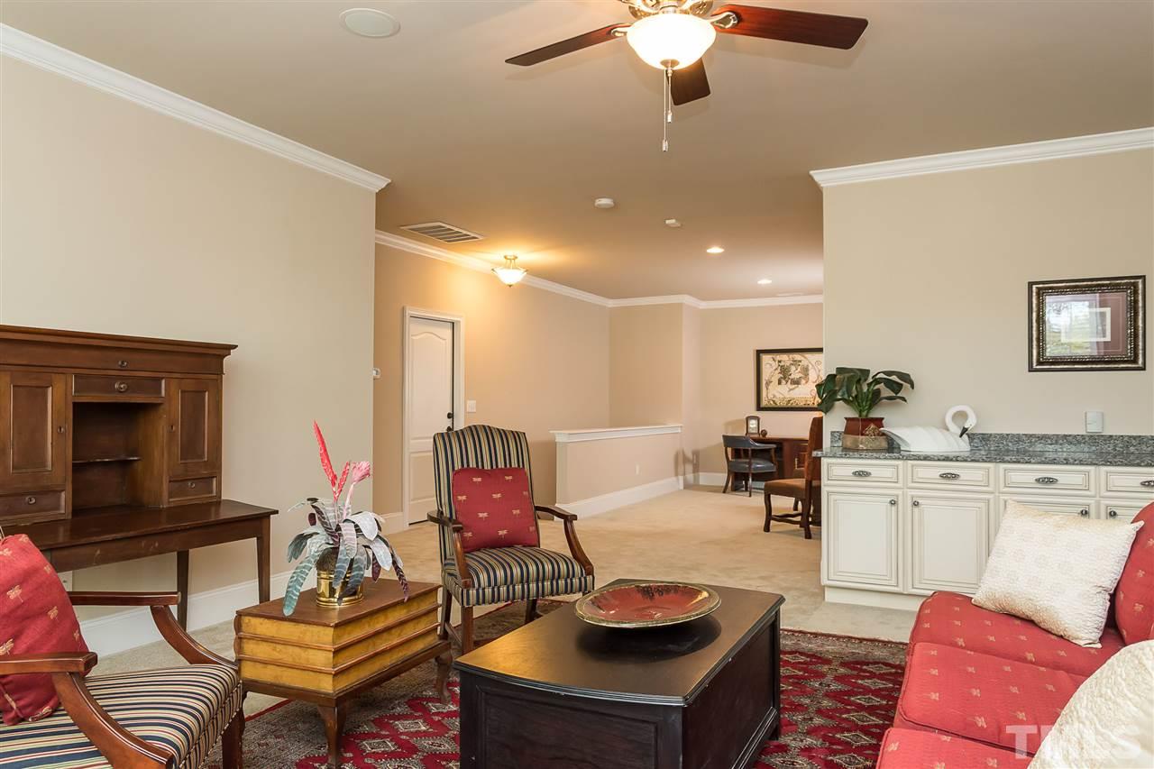 3929 Colinwood Lane Raleigh, NC 27606 - Photo 19 of 24 a living room with furniture and a fireplace