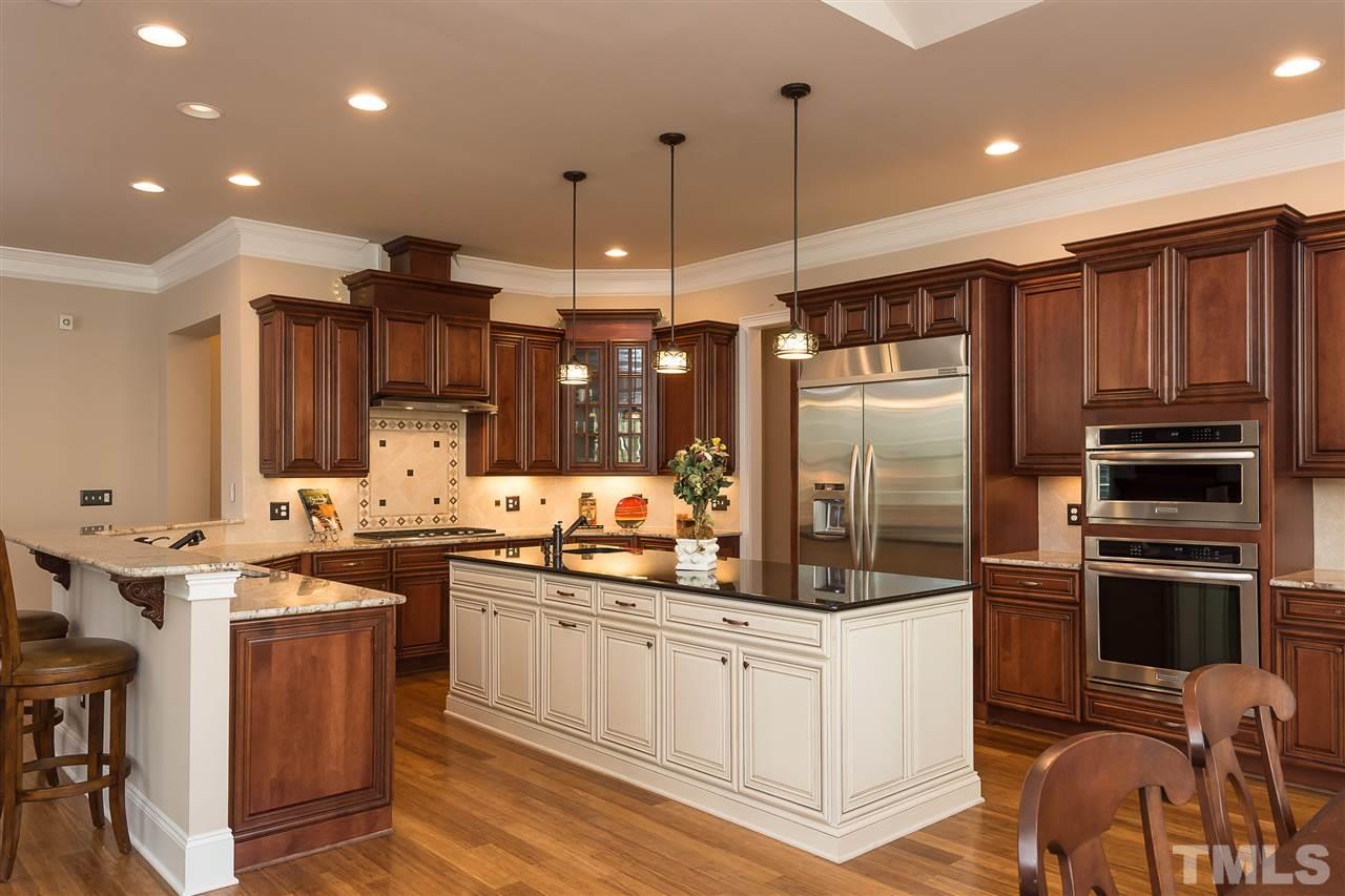 3929 Colinwood Lane Raleigh, NC 27606 - Photo 3 of 24 a kitchen with counter top space appliances and cabinets