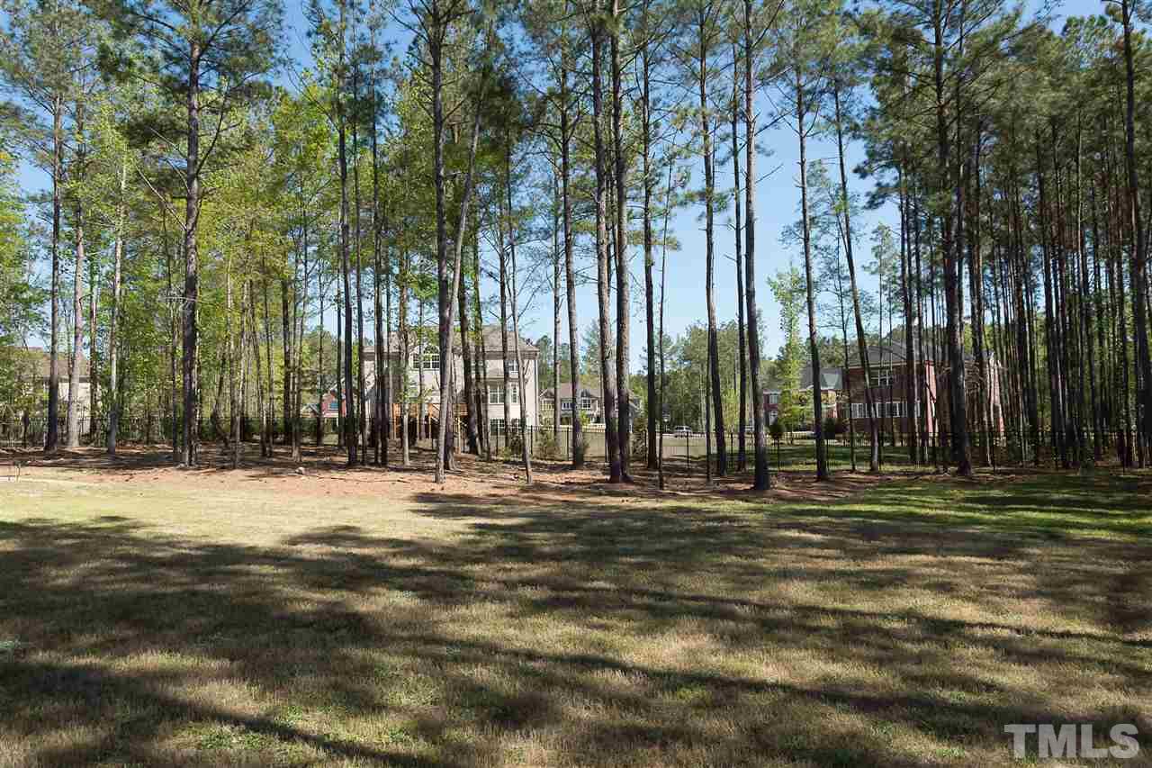 3929 Colinwood Lane Raleigh, NC 27606 - Photo 24 of 24 a big yard with trees in front of it