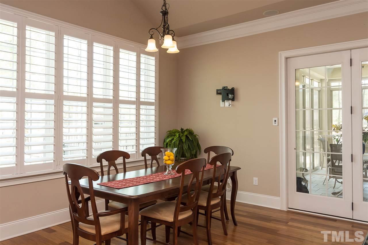 3929 Colinwood Lane Raleigh, NC 27606 - Photo 5 of 24 a view of a dining room with furniture wooden floor and chandelier